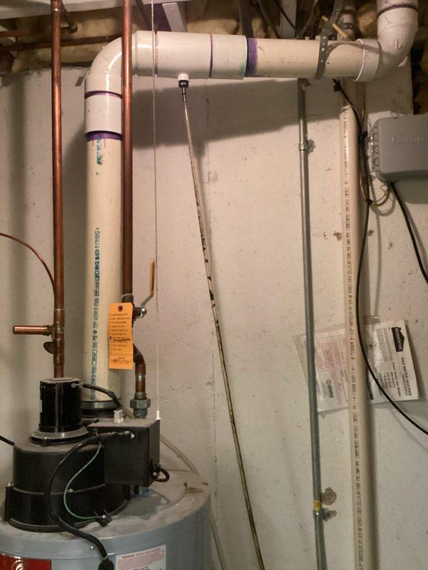 Performed comprehensive assessment of two residential water heaters in basement utility room. Primary unit has failed at 21 years of age, while secondary unit is 17 years old and nearing end of service life. Evaluated existing plumbing configuration including copper supply lines, circulation pump assembly, and PVC venting system. Documented current installation setup with multiple photos showing equipment condition, pipe routing, electrical connections, and safety labeling. Provided detailed estimate for water heater replacement considering existing infrastructure and code compliance requirements.