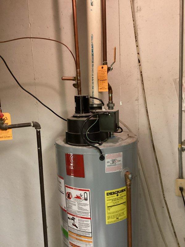 Performed comprehensive assessment of two residential water heaters in basement utility room. Primary unit has failed at 21 years of age, while secondary unit is 17 years old and nearing end of service life. Evaluated existing plumbing configuration including copper supply lines, circulation pump assembly, and PVC venting system. Documented current installation setup with multiple photos showing equipment condition, pipe routing, electrical connections, and safety labeling. Provided detailed estimate for water heater replacement considering existing infrastructure and code compliance requirements.