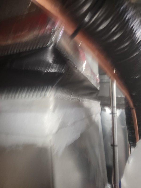 Responded to callback for failed refrigeration issue. Inspected supply-side ductwork above evaporator coil and identified canvas material protruding into airway, restricting airflow. Adjusted and spread canvas material to clear airway obstruction. Documented condition with photographs and submitted images as requested for review. Follow-up documentation completed for management review.