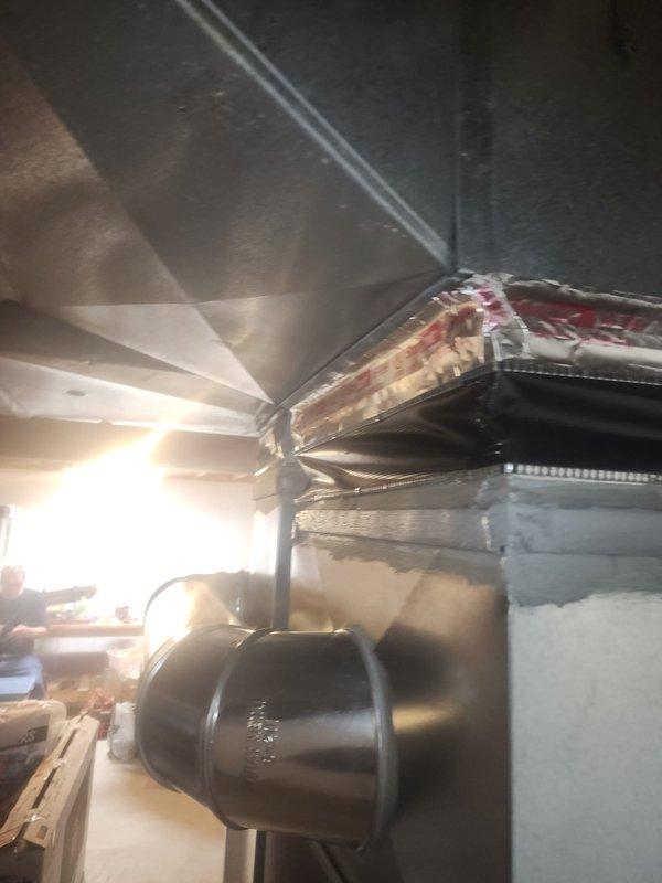 Responded to callback for failed refrigeration issue. Inspected supply-side ductwork above evaporator coil and identified canvas material protruding into airway, restricting airflow. Adjusted and spread canvas material to clear airway obstruction. Documented condition with photographs and submitted images as requested for review. Follow-up documentation completed for management review.