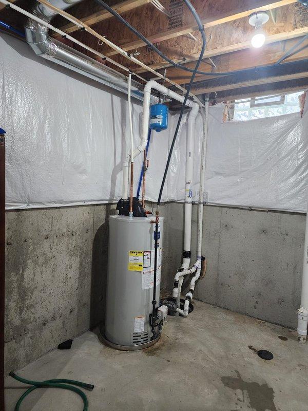 Completed installation of a 50-gallon residential tanked water heater in basement utility area. Unit was properly positioned, secured, and connected to existing plumbing infrastructure including supply lines, discharge piping, and drainage systems. All connections were made to code specifications with appropriate pressure relief valve installation, thermal expansion accommodation, and proper venting. System was tested for functionality and leak-free operation upon completion.