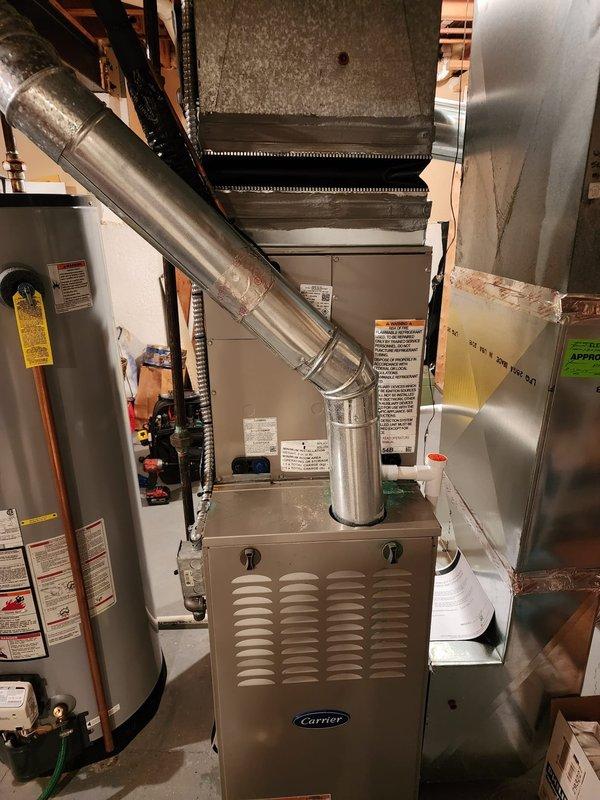 Completed installation of Bryant air conditioning system at residential property. New outdoor condensing unit was set and leveled on concrete pad, with refrigerant lines and electrical connections properly secured and tested. Indoor evaporator coil was installed above existing Carrier furnace, integrated with existing ductwork system using properly sealed transitions. Condensate drainage line was connected to existing PVC drain system. System was evacuated, charged with refrigerant to manufacturer specifications, and tested for proper operation. Verified correct airflow, temperature differential, and electrical parameters. All connections were inspected for leaks using electronic detection methods. System demonstrated proper cooling performance upon completion.