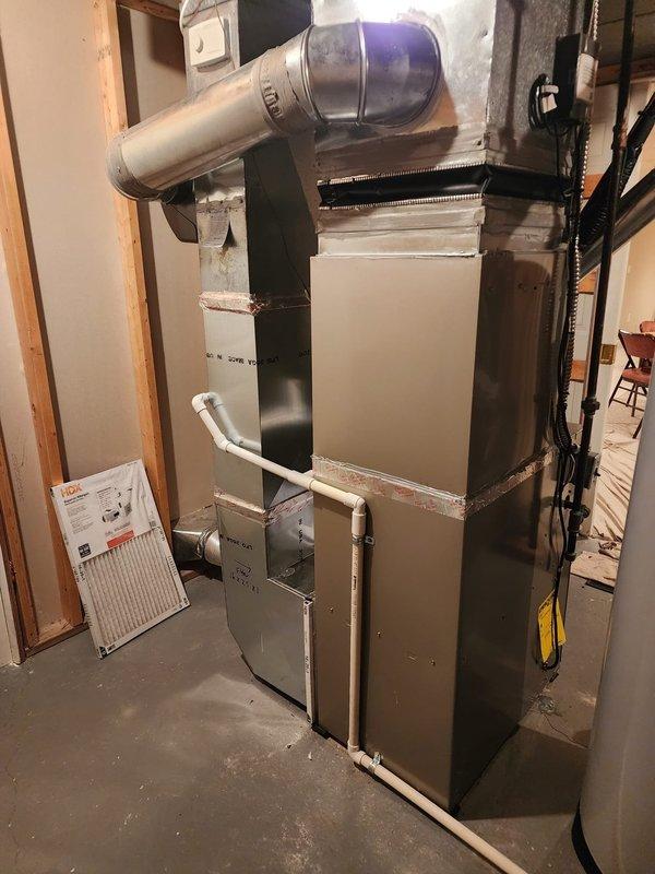 Completed installation of Bryant air conditioning system at residential property. New outdoor condensing unit was set and leveled on concrete pad, with refrigerant lines and electrical connections properly secured and tested. Indoor evaporator coil was installed above existing Carrier furnace, integrated with existing ductwork system using properly sealed transitions. Condensate drainage line was connected to existing PVC drain system. System was evacuated, charged with refrigerant to manufacturer specifications, and tested for proper operation. Verified correct airflow, temperature differential, and electrical parameters. All connections were inspected for leaks using electronic detection methods. System demonstrated proper cooling performance upon completion.