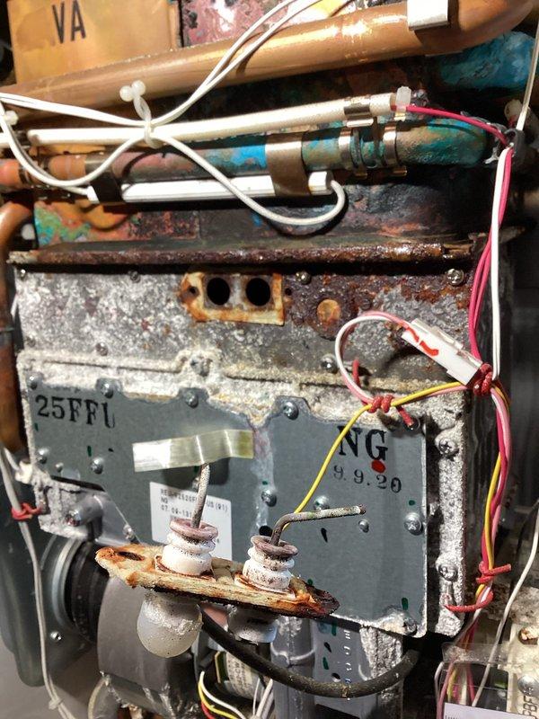 Responded to service call for leaking tankless water heater. Upon arrival, performed comprehensive visual inspection of unit and identified significant corrosion and mineral buildup on internal components, mounting brackets, and heat exchanger assembly. Utilized inspection camera with LCD display to conduct detailed internal assessment of heat exchanger and piping system, revealing accumulated scale deposits and deterioration within the unit's water pathways. Documented extensive rust damage to control panel housing, mounting hardware, and structural components indicating prolonged moisture exposure. Photographed corroded electrical connections and mineral deposits throughout the assembly. Provided customer with detailed findings regarding the unit's deteriorated condition and recommended repair or replacement options based on the severity of internal corrosion and component degradation observed during inspection.