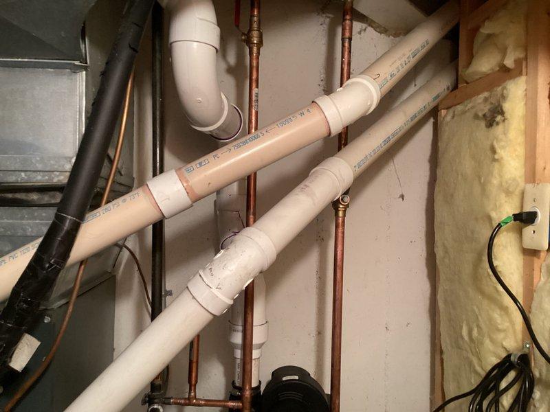 Completed installation of two 50-gallon tanked water heaters in residential utility space. Connected supply and discharge piping using copper lines, installed PVC venting system with proper pitch and termination, and verified all connections for leaks. Both units tested and operational with safety labels intact and green approval tags affixed.