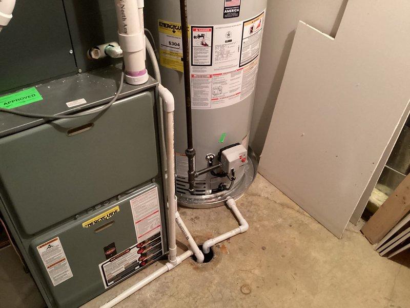 Completed installation of two 50-gallon tanked water heaters in residential utility space. Connected supply and discharge piping using copper lines, installed PVC venting system with proper pitch and termination, and verified all connections for leaks. Both units tested and operational with safety labels intact and green approval tags affixed.