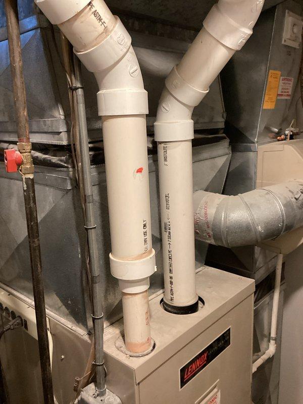 Conducted comprehensive estimate for complete HVAC system replacement of 23-year-old equipment. Assessed existing Lennox furnace installation in basement mechanical room with PVC venting, copper refrigerant lines, and metal ductwork connections. Evaluated outdoor condenser unit positioned on pad against exterior foundation with PVC condensate routing and glass block basement window proximity. Customer requested quiet, energy-efficient replacement system to address excessive noise levels and aging equipment concerns.