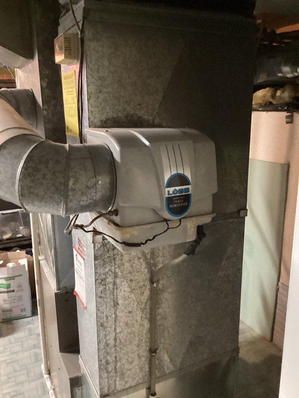 Responded to red tag furnace with multiple holes in heat exchanger. Provided replacement estimate for complete HVAC system due to failed heat exchanger posing safety hazard. Documented existing equipment configuration including furnace, humidifier, ductwork, and condensate drainage system with photos for customer records.