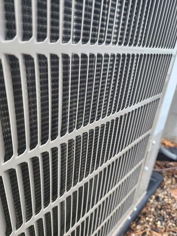 Completed scheduled cooling system maintenance and tune-up on HVAC system. Performed comprehensive inspection of outdoor condenser unit, verifying proper airflow through coil fins and grille assembly. Unit showed normal environmental weathering with minor dirt accumulation on heat exchanger fins. Inspected indoor evaporator coil assembly and discovered significant frost buildup on coil surface, indicating potential airflow restriction or refrigerant charge issue. Examined refrigerant lines, electrical connections, and condensate drain pan for proper operation. Documented equipment condition with photos for maintenance records. System currently operational but frost accumulation requires monitoring or follow-up service to prevent efficiency loss and potential compressor damage.