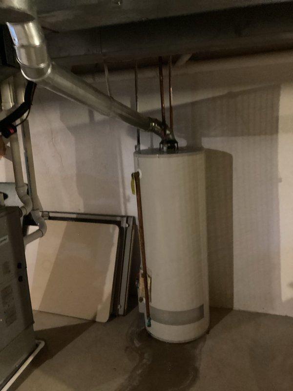 Conducted on-site assessment and provided estimate for residential water heater replacement in basement utility area. Evaluated existing cylindrical tank-style water heater, documenting current installation configuration including copper supply piping, top-mounted connections, and proper venting arrangements. Photographed equipment and surrounding mechanical space to support estimate preparation for complete water heater replacement with new unit of appropriate capacity and specifications.