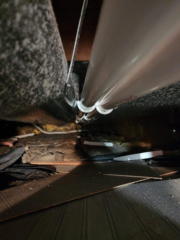Completed installation of Lennox brand high-efficiency furnace in mechanical room. Connected intake and exhaust venting using white PVC piping routed vertically from unit, along with auxiliary drainage lines. Installed metallic supply ductwork with proper transitions from furnace plenum through attic space, securing all connections and ensuring proper airflow pathways. Unit positioned on tile floor with all manufacturer specifications verified and labeled. System tested and confirmed operational upon completion.