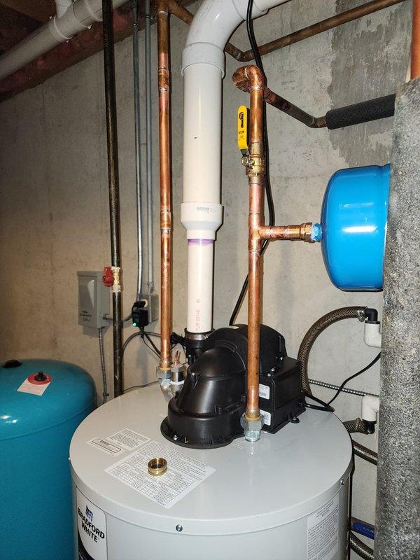 Installed a 50-gallon Bradford White electric water heater in residential basement utility area, including connection of all copper supply and discharge piping. Added ball valve to system for improved isolation capability and installed powered anode rod for extended tank life and corrosion protection.
