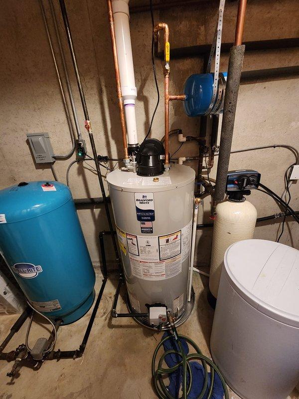 Installed a 50-gallon Bradford White electric water heater in residential basement utility area, including connection of all copper supply and discharge piping. Added ball valve to system for improved isolation capability and installed powered anode rod for extended tank life and corrosion protection.