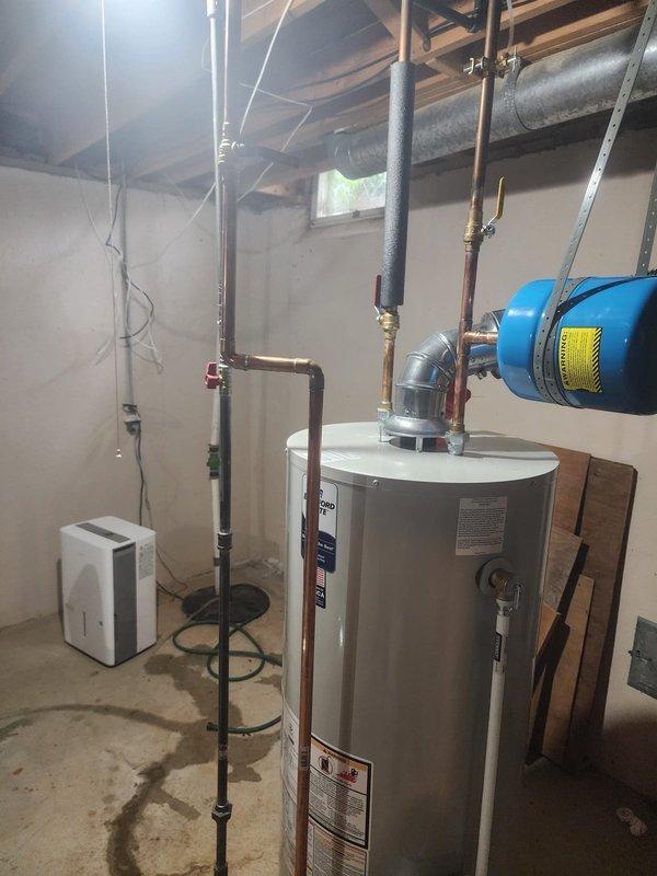 Responded to callback regarding hot water heater experiencing extended heating time of 20 minutes. Upon inspection, verified water heater installation, expansion tank, and associated copper piping connections in basement mechanical room. Documented equipment condition and plumbing configuration with photos showing proper mounting, valve placement, and system components functioning as installed.