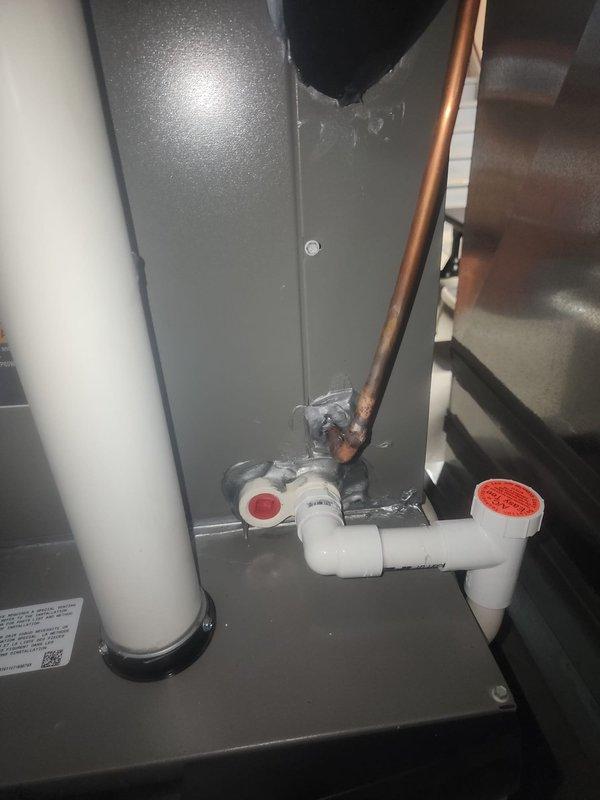 Completed scheduled AC maintenance and system inspection. Verified proper operation of condensate drain system including P-trap configuration with PVC piping, inspected expansion tank and associated plumbing connections, and documented all mechanical components within the HVAC utility space. All equipment found operating within normal parameters with no immediate service needs identified.