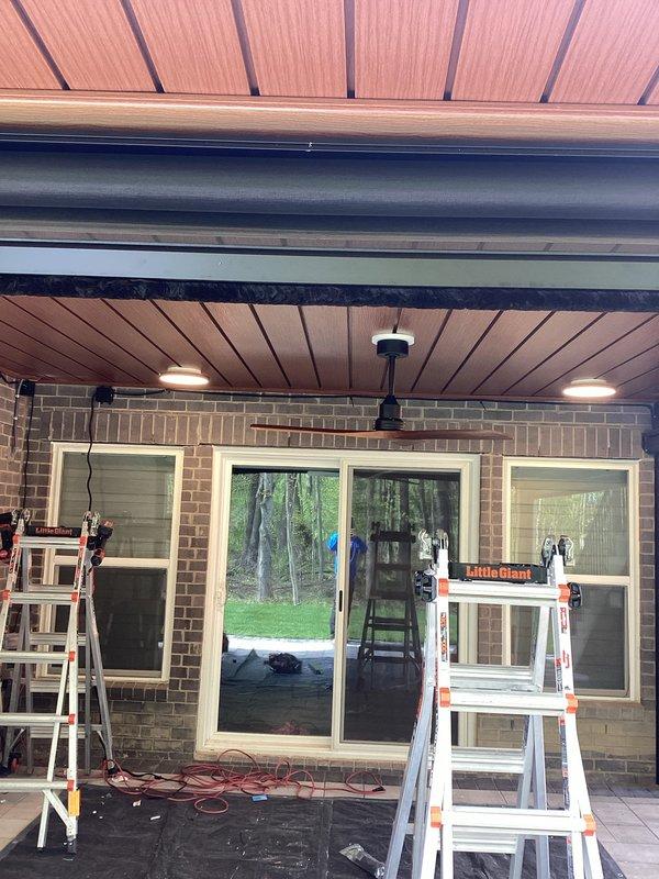 Completed continuation electrical work from previous service call, installing recessed LED lighting fixtures in covered patio ceiling. Installed two round recessed LED lights with bright white output in wood-paneled ceiling area. All fixtures tested and confirmed operational upon completion, with pricing to be provided separately.