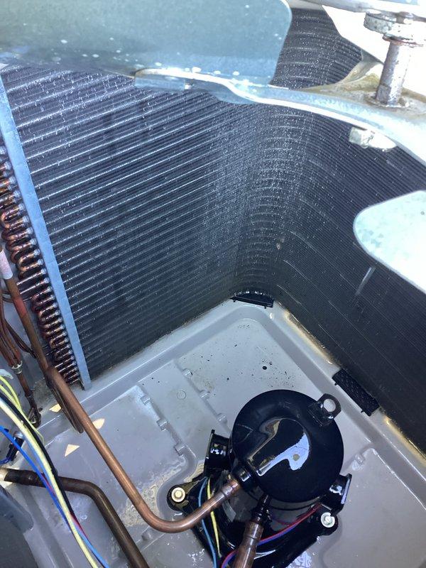 Performed preventative maintenance inspection on HVAC system in response to ecobee thermostat service reminder notification. Inspected air handler interior components including evaporator coils, blower motor assembly, and refrigerant lines, confirming all components operational with no visible defects. Examined outdoor condensing unit electrical components including capacitor, wiring connections, and refrigerant line connections, verifying proper operation and system functionality.