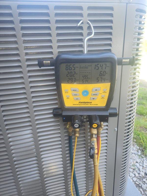 Performed seasonal AC startup and system diagnostics on outdoor condensing unit. Connected digital manifold gauges to measure refrigerant pressures and temperatures, verifying proper system operation and refrigerant charge levels. All readings were within normal operating parameters, confirming the unit is ready for the cooling season.