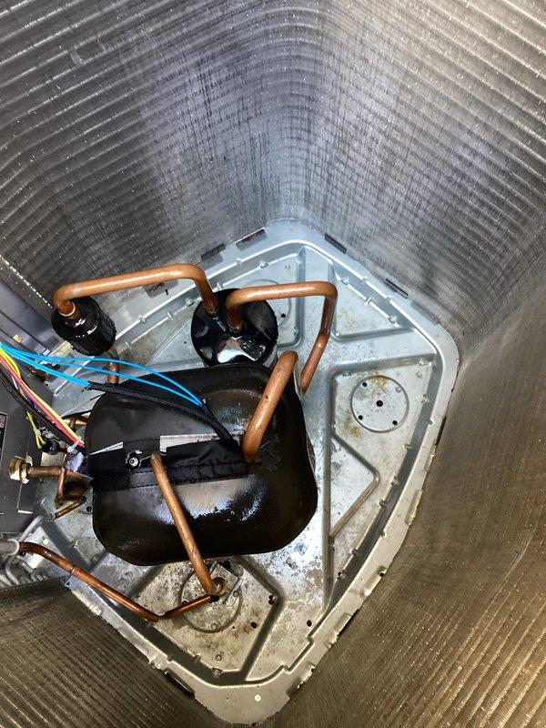 Completed routine AC maintenance on residential cooling system. Inspected air handler unit interior, including evaporator coil assembly, refrigerant lines, electrical connections, and condensate drain pan with noted mineral deposits and water staining. Serviced outdoor condenser unit, verified proper operation, and cleared vegetation growth from around unit base to ensure adequate airflow and system efficiency.