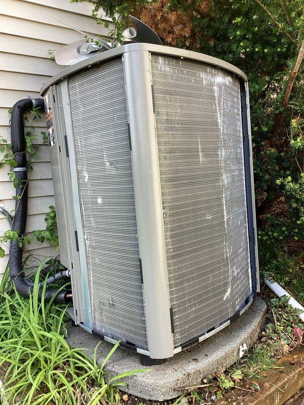 Completed routine AC maintenance on residential cooling system. Inspected air handler unit interior, including evaporator coil assembly, refrigerant lines, electrical connections, and condensate drain pan with noted mineral deposits and water staining. Serviced outdoor condenser unit, verified proper operation, and cleared vegetation growth from around unit base to ensure adequate airflow and system efficiency.