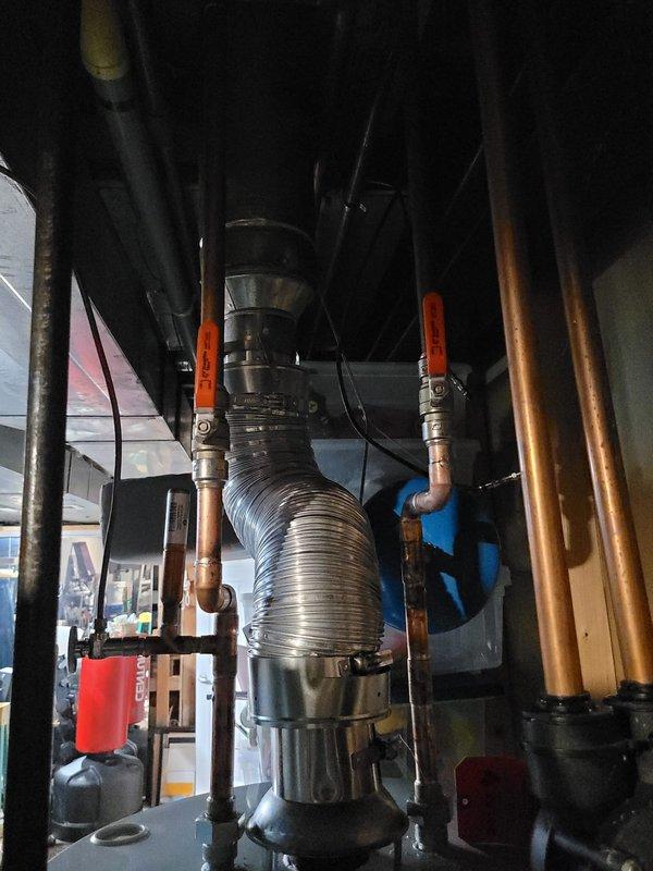 Completed installation of a 50-gallon Bradford White tanked water heater in residential utility space. Connected all copper supply and discharge piping, installed expansion tank, and integrated system with existing water treatment equipment. All plumbing connections were secured with proper fittings and valves, flexible ductwork was positioned for venting, and unit was tested for proper operation upon completion.