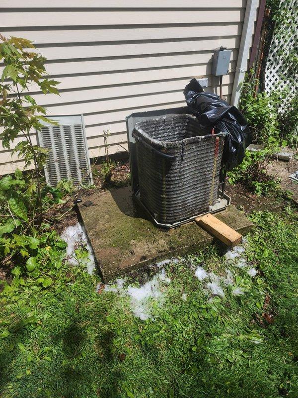 Completed comprehensive AC tune-up on outdoor condenser unit located in backyard. Performed standard maintenance protocol including inspection of evaporator coil assembly, which showed moderate dust accumulation on fins and presence of condensate safety switch (orange float device) functioning properly. Inspected condenser unit with horizontal fin configuration, verified refrigerant line connections and insulation integrity, and checked unit mounting on concrete pad. No operational issues identified during inspection; system components found in serviceable condition with typical environmental debris accumulation for outdoor installation.