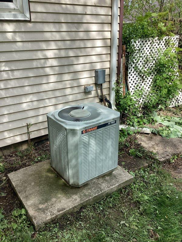 Conducted comprehensive site assessment for complete HVAC system replacement at residential property. Evaluated existing Trane outdoor condenser unit and associated indoor components, documenting current equipment condition, installation configuration, and spatial requirements. Photographed exterior condenser placement on concrete pad with existing electrical disconnect and wall-mounted conduit, as well as basement utility area showing ceiling-mounted support infrastructure and available routing pathways for new refrigerant lines and electrical connections. Provided detailed replacement estimate including equipment specifications, labor requirements, and installation scope to upgrade aging system with modern high-efficiency equipment.