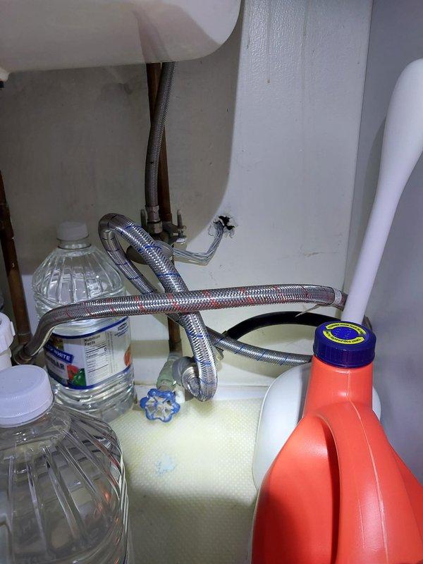 Responded to callback regarding water pressure loss and lack of water to appliances following hot water tank installation. Inspected under-sink plumbing connections and water supply lines, verifying proper installation of braided stainless steel flex hoses and shut-off valve operation. Confirmed water flow restoration to fixtures and documented system functionality with no charge to customer per warranty protocol.