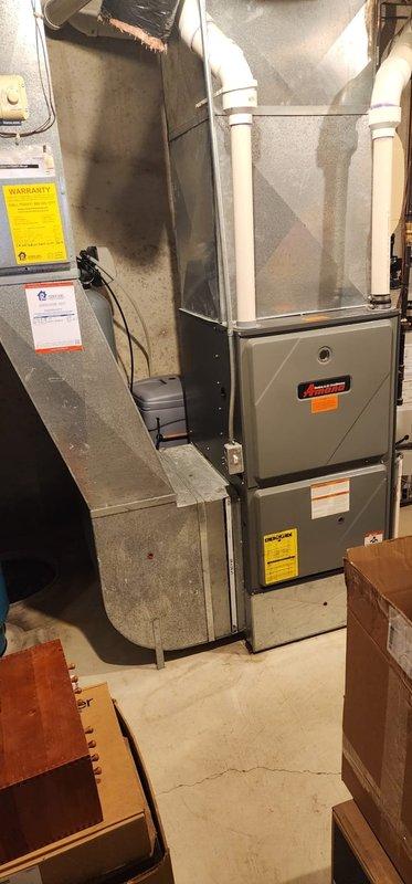 Completed scheduled furnace maintenance on residential forced-air heating system. Upon inspection, discovered significant rust and corrosion throughout the interior components, particularly on the lower compartment floor and base plate, indicating moisture exposure and age-related deterioration. Performed standard maintenance procedures including inspection of heat exchanger assembly, blower motor, electrical connections, and ductwork connections. Documented equipment condition with photographs for service records, noting the extensive rust damage on metal surfaces and internal components that may require future attention or replacement.