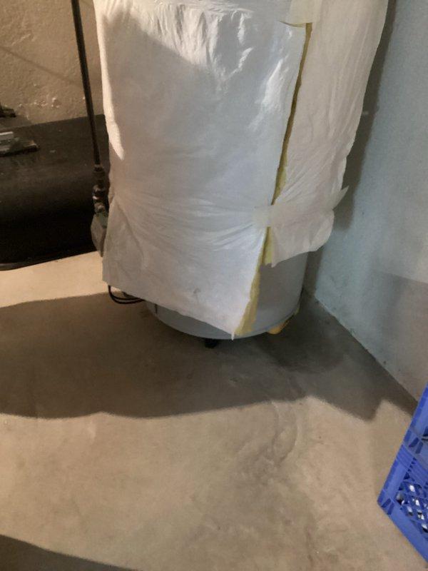 Conducted on-site assessment for water heater replacement in residential basement utility area. Evaluated existing water heater installation, surrounding plumbing infrastructure, and available space for new unit installation. Documented current equipment configuration including water softener system with associated PVC piping, overhead ductwork clearances, and electrical service routing. Photographed existing installation showing protective measures in place and equipment layout to facilitate accurate estimate preparation for complete water heater replacement.