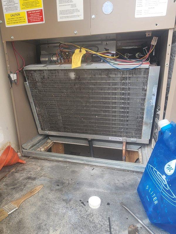 # HVAC Maintenance - Cooling System Service

Performed comprehensive preventive maintenance on residential air conditioning unit. Accessed interior compartment and inspected evaporator coil, which exhibited moderate accumulation of dust and debris between fins. Examined electrical connections, wire harnesses, and control components in upper compartment section, verifying all connections were secure and properly terminated. Inspected mounting hardware, support blocks, and cabinet interior for structural integrity and proper installation. All safety labels and warning placards confirmed present and legible. Unit operational following maintenance procedures.