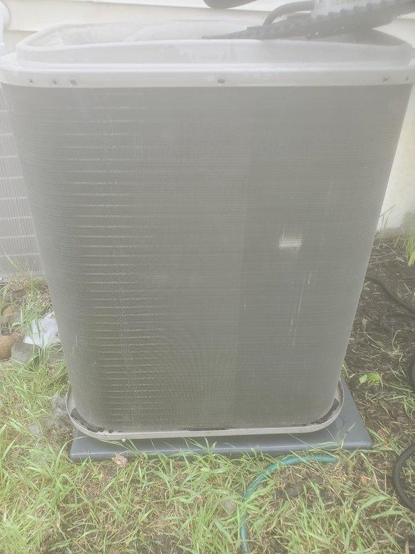 Completed comprehensive cooling system maintenance and tune-up on dual HVAC system. Performed standard preventative maintenance procedures on both indoor air handler and outdoor condensing unit. Inspected condensate drain pan in attic space, noting standing water present with copper refrigerant lines showing age-related oxidation and patina formation. Verified proper drainage through blue condensate line. Serviced outdoor condenser unit positioned on ground-level pad, checking refrigerant lines, electrical connections, and airflow through coil fins. System tested and confirmed operational upon completion. All components functioning within normal parameters.