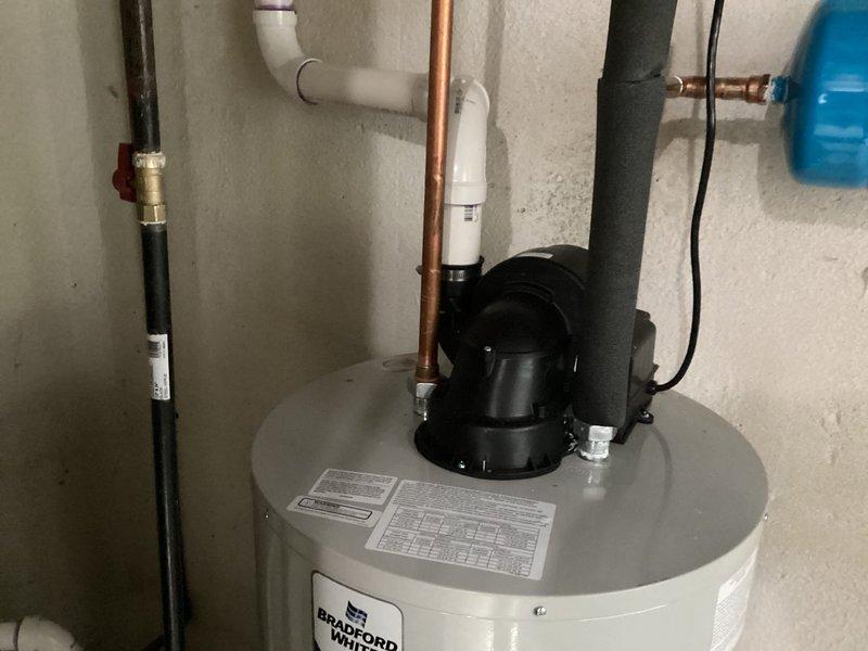 Installed a 50-gallon Bradford White tanked water heater in basement utility room, including all necessary plumbing connections with copper supply lines, PVC venting system with power vent blower assembly, and electrical hookup to breaker panel. Completed full installation per manufacturer specifications with proper gas connections, temperature and pressure relief valve, and all code-required safety components.