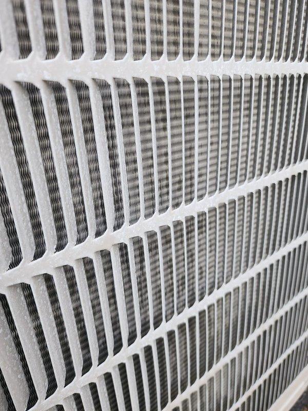 Completed comprehensive cooling system maintenance and tune-up on HVAC unit. Inspected compressor assembly, refrigerant lines, electrical connections, and air filter system; all components found in proper working condition with system operating normally. Documented equipment condition with photographs showing compressor unit with normal condensation, copper refrigerant lines, and clean air filter assembly.
