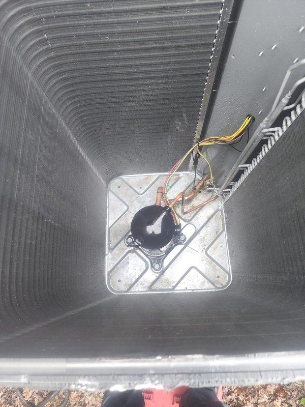Completed AC maintenance tune-up on residential split system. Inspected outdoor condenser unit, verified proper operation of compressor and fan motor, checked refrigerant levels, and examined condensate drain pump assembly in collection pan. All components found operating within normal parameters; system ready for cooling season.