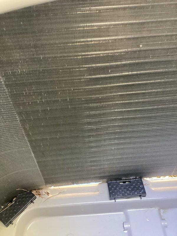Completed scheduled preventative maintenance on residential air conditioning system and hot water heater. Performed thorough inspection of A/C evaporator coil, confirmed proper fin alignment and verified adequate airflow through heat exchanger. Inspected refrigerant line insulation and electrical connections within air handler cabinet, noting secure installation and proper routing of copper lines and control wiring. Checked condensate drain pan for proper drainage and cleaned minor debris accumulation. All components operating within normal parameters with no immediate service needs identified.