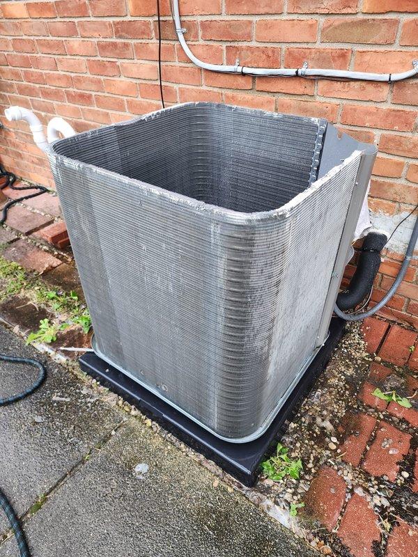Completed routine air conditioning maintenance on outdoor condensing unit and indoor air handler components. Inspected blower wheel assembly inside air handler, noting normal dust accumulation on impeller blades, and examined outdoor condenser unit positioned on concrete pad against building exterior, confirming proper installation and operational readiness of all accessible components.