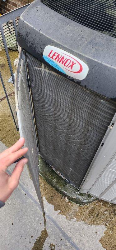 Completed preventive maintenance inspection on Lennox outdoor condensing unit. Unit exhibited significant biological growth including moss and algae accumulation on interior framework, panels, and support structures, along with debris buildup in condenser coil fins and base area. Documented existing conditions showing environmental exposure, oxidation on copper refrigerant lines, and organic matter accumulation requiring attention to maintain optimal system performance and efficiency.