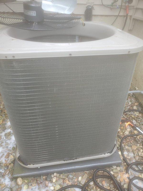 Completed routine preventive maintenance on a 4-year-old residential air conditioning system under the Worry Free Service Agreement. Performed comprehensive AC tune-up on the outdoor condensing unit, which included inspection of the compressor, condenser coil, fan motor assembly, and refrigerant lines. Verified proper operation of all electrical components and connections. Inspected the indoor air handler and condensate management system located in the attic space, including the drain pan, condensate pump with associated wiring, and copper refrigerant line connections. Noted existing water staining on drain pan consistent with normal condensate drainage patterns. Confirmed condensate removal system functioning properly with no active leaks or blockages observed. Checked refrigerant line insulation and connections at both indoor and outdoor units. Outdoor unit positioned on composite pad with adequate clearance and airflow around condenser coil. All system components operating within no