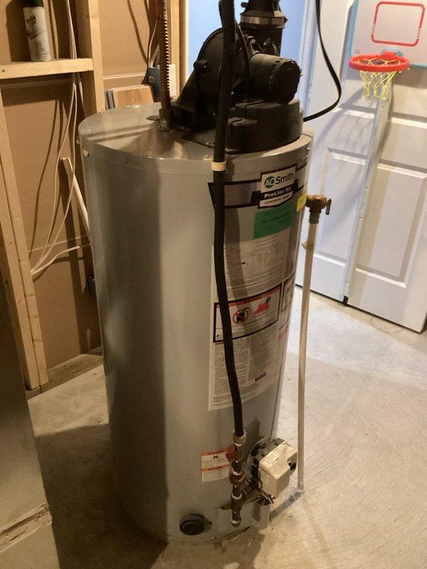 Performed water heater evaluation and provided replacement estimate for AO Smith tank-style unit with recirculation pump system. Previous anode rod replacement failed to resolve ongoing issues. Assessed existing installation, documented current equipment condition, discussed replacement options and available utility rebates with homeowner.