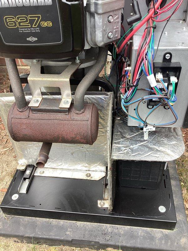 # Generator Service Completed

Performed scheduled preventive maintenance on outdoor generator unit. Conducted thorough visual inspection of all electrical connections, wiring harnesses, and control components. Verified integrity of power distribution system including red, blue, and multi-conductor wire bundles throughout the unit. Inspected white electrical control module and confirmed proper termination of all connections.

Examined compressor assembly and associated refrigerant lines for signs of wear or degradation. Noted weathering consistent with normal outdoor exposure on brown cylindrical accumulator vessel and metal mounting brackets. Replaced worn brass and chrome threaded fittings to ensure proper seal integrity and prevent potential leaks. Cleaned accumulated dirt and debris from equipment housing and concrete mounting pad. Verified unit operational parameters and confirmed system ready for continued service. All components functioning within normal specifications upon comp