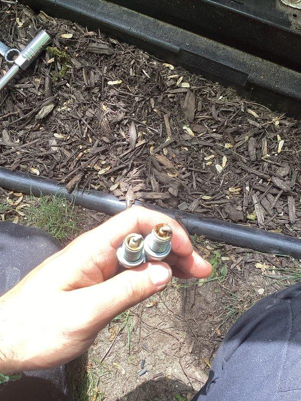 Performed routine maintenance on Vanguard 627cc generator system. Removed and replaced three spark plugs showing normal wear patterns. Inspected electrical control panel connections, wiring harnesses, and mounting hardware to verify secure installation and proper operation of the backup power unit.