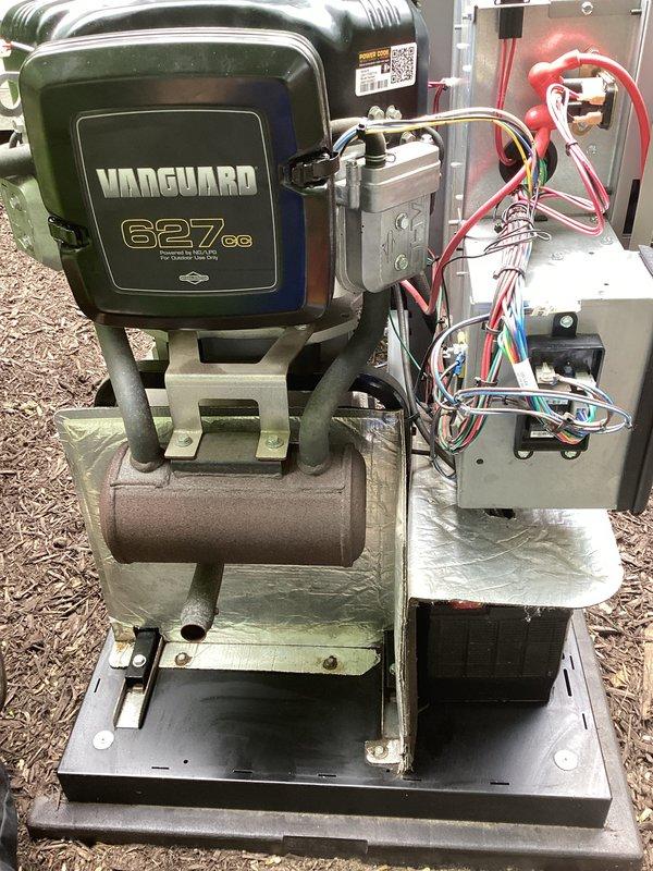 Performed routine maintenance on Vanguard 627cc generator system. Removed and replaced three spark plugs showing normal wear patterns. Inspected electrical control panel connections, wiring harnesses, and mounting hardware to verify secure installation and proper operation of the backup power unit.