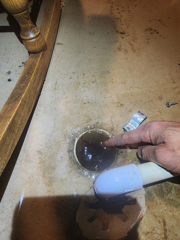 Responded to service call for furnace condensate drain leak. Upon inspection, found condensate drain line discharging water onto basement floor near floor drain. Condensate drainage system was not properly routed into the floor drain, causing water accumulation on concrete surface around drain area. Repositioned and secured condensate line to ensure proper drainage directly into floor drain opening. Verified condensate flow and confirmed no further leakage onto floor. System operating properly with condensate now draining correctly.