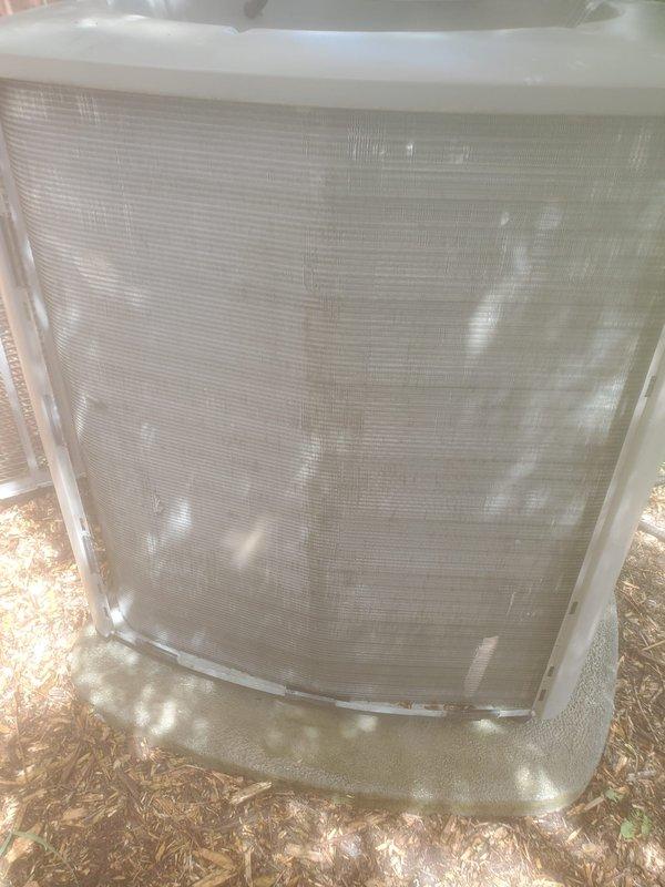 Completed routine AC maintenance on residential split system. Performed visual inspection of outdoor condensing unit, which showed good overall condition with protective mesh grille intact and unit properly positioned on concrete pad. Inspected indoor air handling components including humidifier assembly mounted in supply plenum. Noted minor rust staining and mineral deposits in humidifier drain pan, typical of normal operation. Verified electrical connections secure and all wiring in acceptable condition. System operating within normal parameters upon completion of maintenance visit.