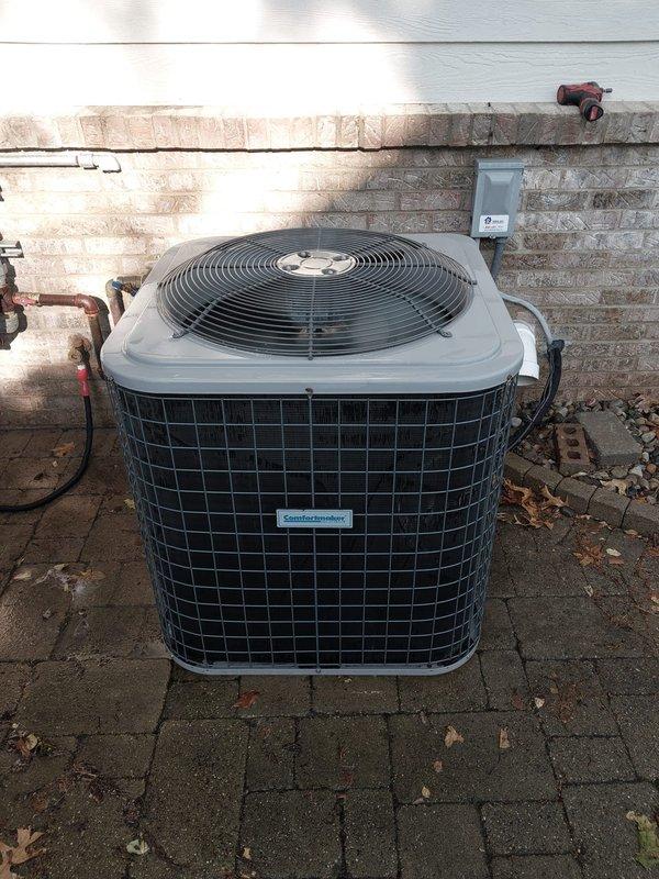 Completed scheduled A/C maintenance on outdoor condenser unit. Performed standard preventive maintenance inspection of the system, including visual assessment of the condenser unit exterior, refrigerant lines, and electrical connections. Documented equipment condition with photographs showing the unit positioned on paver patio against brick wall with copper refrigerant lines and pressure gauge assembly visible. Unit appeared to be in operational condition with standard wear consistent with normal use.