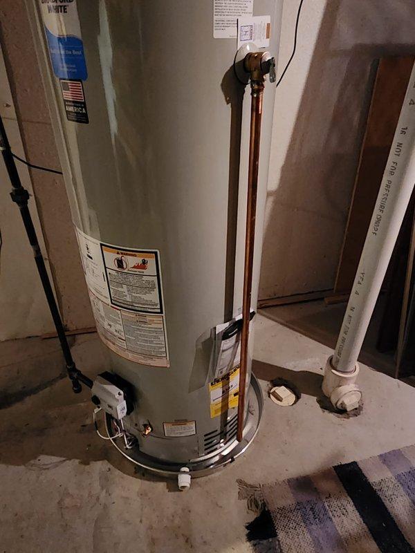 Completed callback service to address relief valve discharge piping on previously installed 50-gallon Bradford White water heater. Replaced existing discharge piping with code-compliant materials to meet 2015 Michigan Residential Code Chapter 28 requirements. Verified all plumbing connections, gas line assembly, and proper drainage pan installation, documenting completed work with photographs per service protocol.