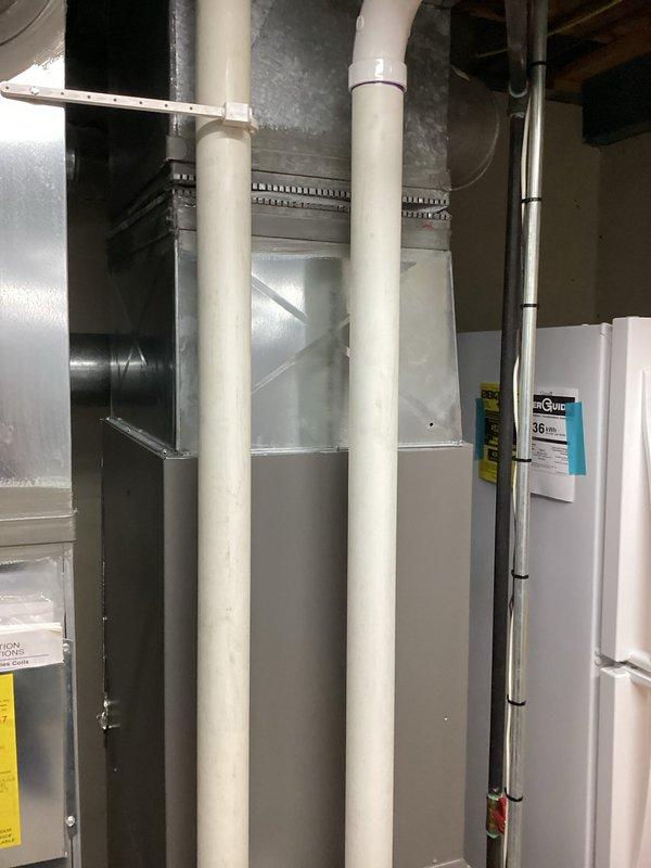 Provided comprehensive HVAC system replacement estimate for residential installation. Assessed existing basement utility room configuration including Lennox furnace unit, galvanized metal ductwork plenum with proper seam and rivet connections, white PVC condensate drain and vent piping with secure mounting brackets, and associated plumbing connections with shutoff valves. Documented current system layout featuring air handler equipment, vertical exhaust/intake venting, insulated water lines, and organized pipe routing on concrete floor foundation. Generated multiple quote options (04082-02 and 04082-03) for air conditioning replacement with estimated 4-6 PM installation timeframe, evaluating integration requirements with existing ductwork infrastructure and mechanical room space constraints.