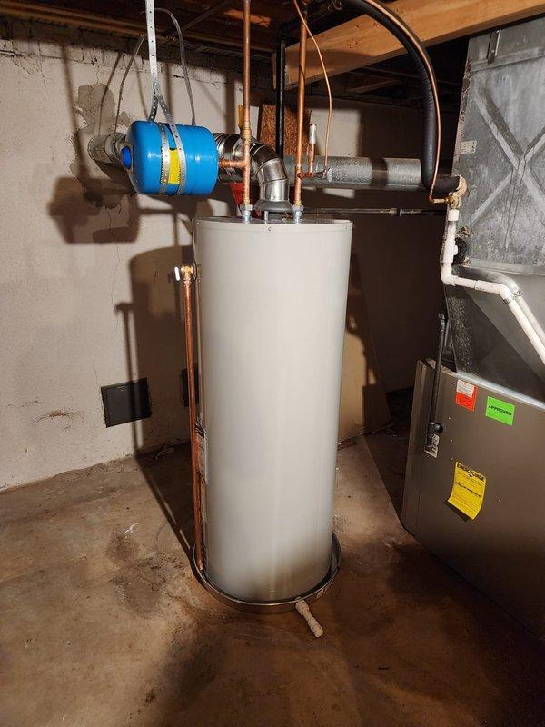 Successfully installed a new 50-gallon residential tanked water heater in the basement mechanical room. The unit was properly positioned on the concrete floor with all copper supply line connections completed at the top of the tank, including installation of appropriate shut-off valves. A blue expansion tank was mounted to the wall and integrated into the system to manage thermal expansion and maintain proper system pressure. Additionally, addressed the sagging hot water line by installing a support clamp to secure the piping and prevent future stress on the connections. All plumbing connections were tested for leaks, and the system was verified to be operating correctly upon completion.