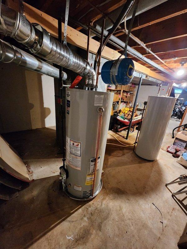 Successfully installed a new 50-gallon residential tanked water heater in the basement mechanical room. The unit was properly positioned on the concrete floor with all copper supply line connections completed at the top of the tank, including installation of appropriate shut-off valves. A blue expansion tank was mounted to the wall and integrated into the system to manage thermal expansion and maintain proper system pressure. Additionally, addressed the sagging hot water line by installing a support clamp to secure the piping and prevent future stress on the connections. All plumbing connections were tested for leaks, and the system was verified to be operating correctly upon completion.
